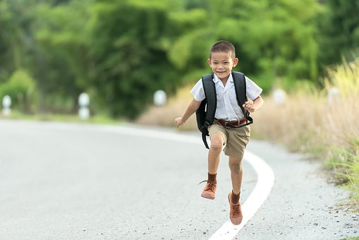 boy running with backpack